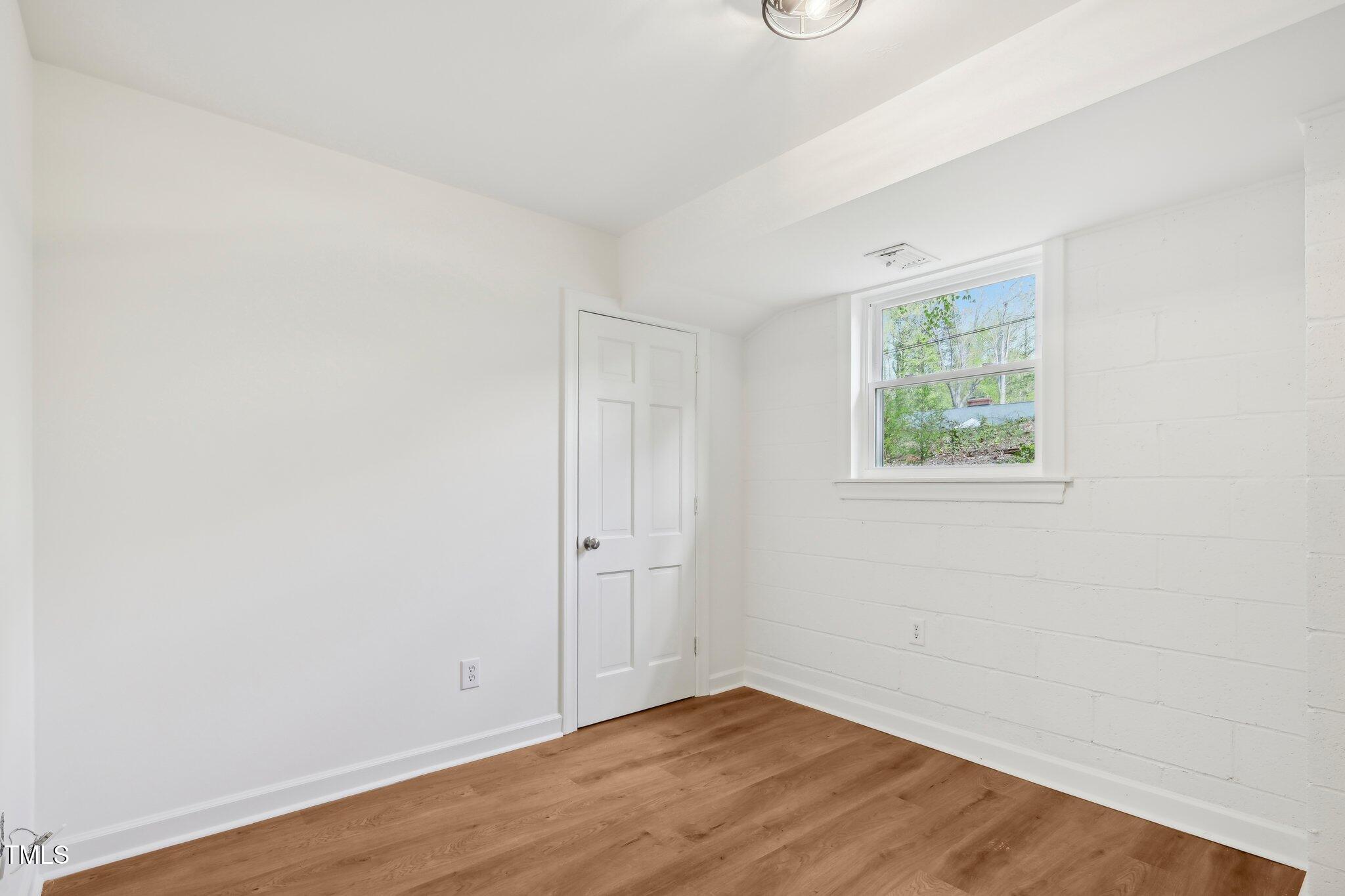 4815 Oak Park Road Raleigh, NC 27612 - Photo 35 of 50 an empty room with wooden floor and windows