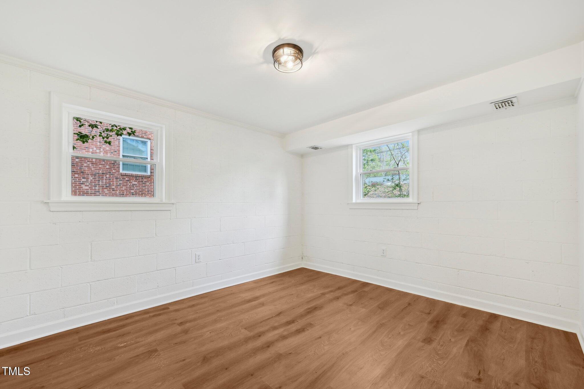 4815 Oak Park Road Raleigh, NC 27612 - Photo 37 of 50 a view of a room with wooden floor and window