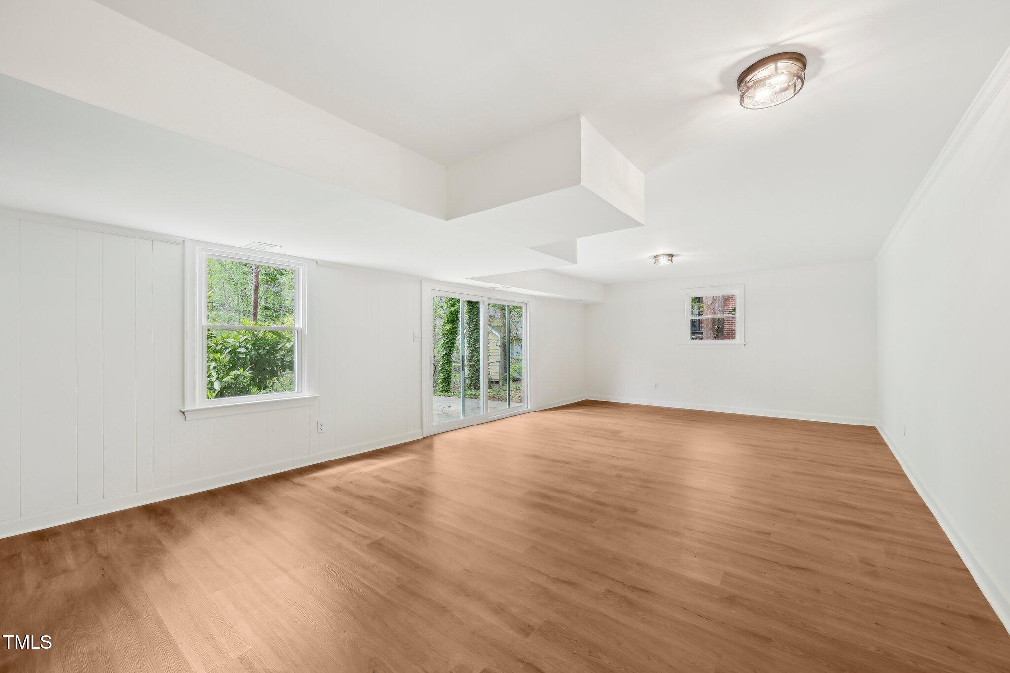 4815 Oak Park Road Raleigh, NC 27612 - Photo 39 of 50 an empty room with wooden floor and windows