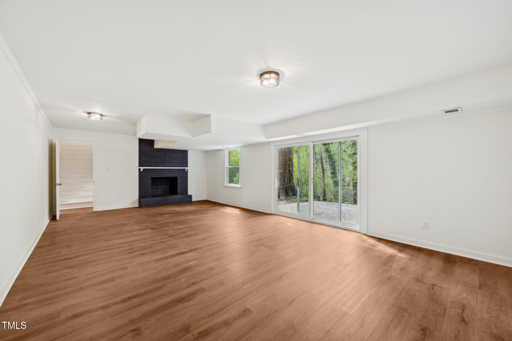 4815 Oak Park Road Raleigh, NC 27612 - Photo 41 of 50 a view of empty room with wooden floor and fireplace