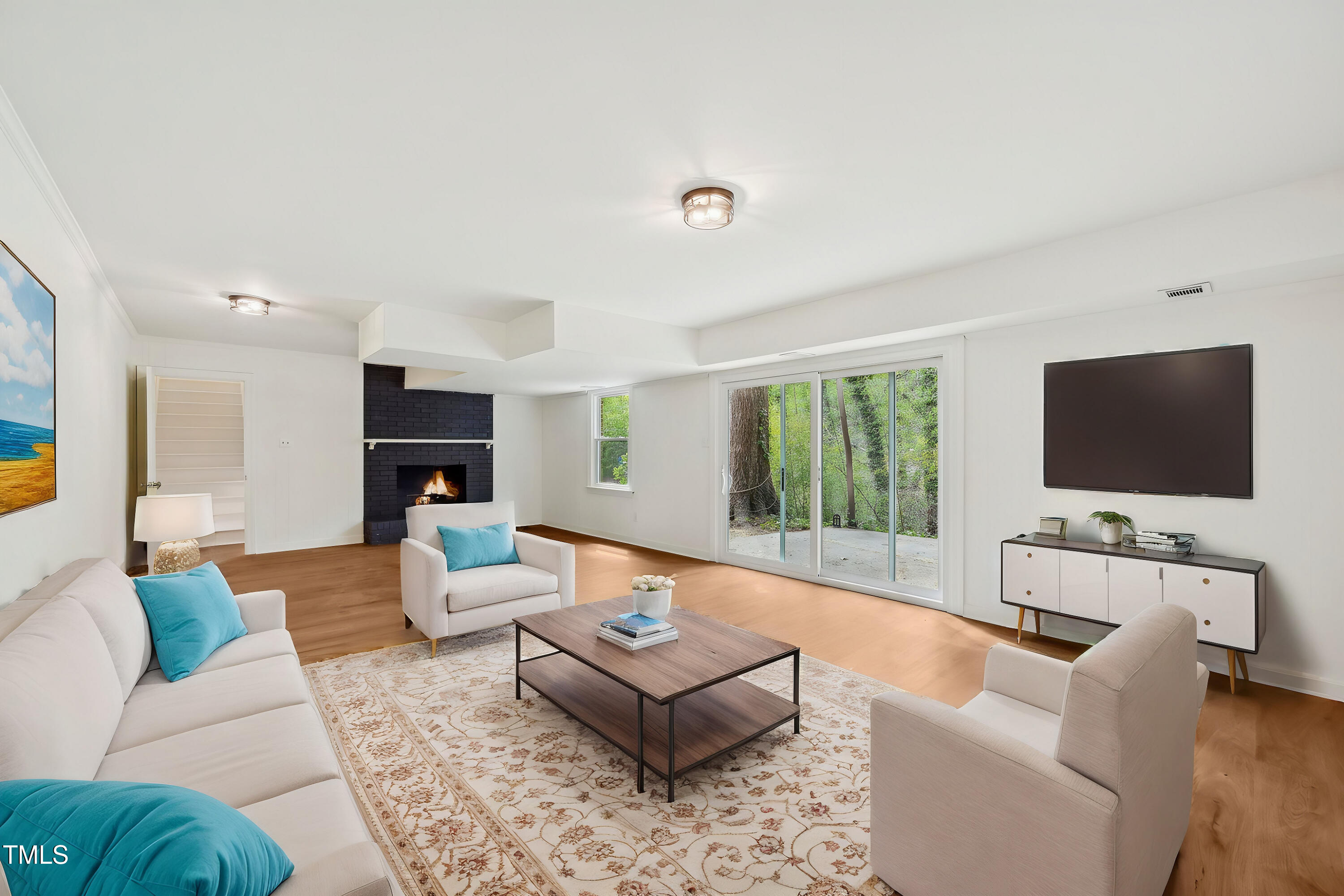 4815 Oak Park Road Raleigh, NC 27612 - Photo 42 of 50 a living room with furniture and a flat screen tv