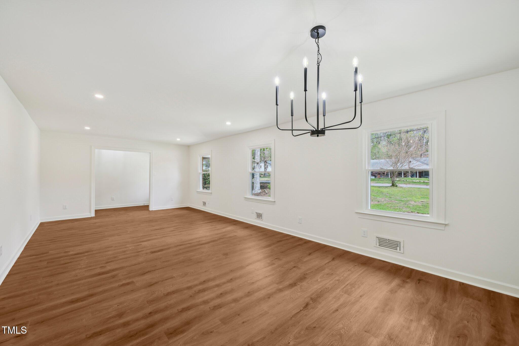 4815 Oak Park Road Raleigh, NC 27612 - Photo 10 of 50 a view of empty room with wooden floor and ceiling fan