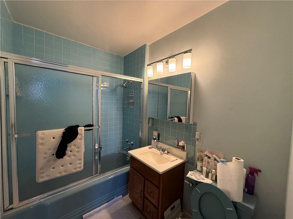 5100 Fifth Avenue, Unit 509 Pittsburgh, PA 15232 - Photo 12 of 26 a bathroom with a sink and mirror