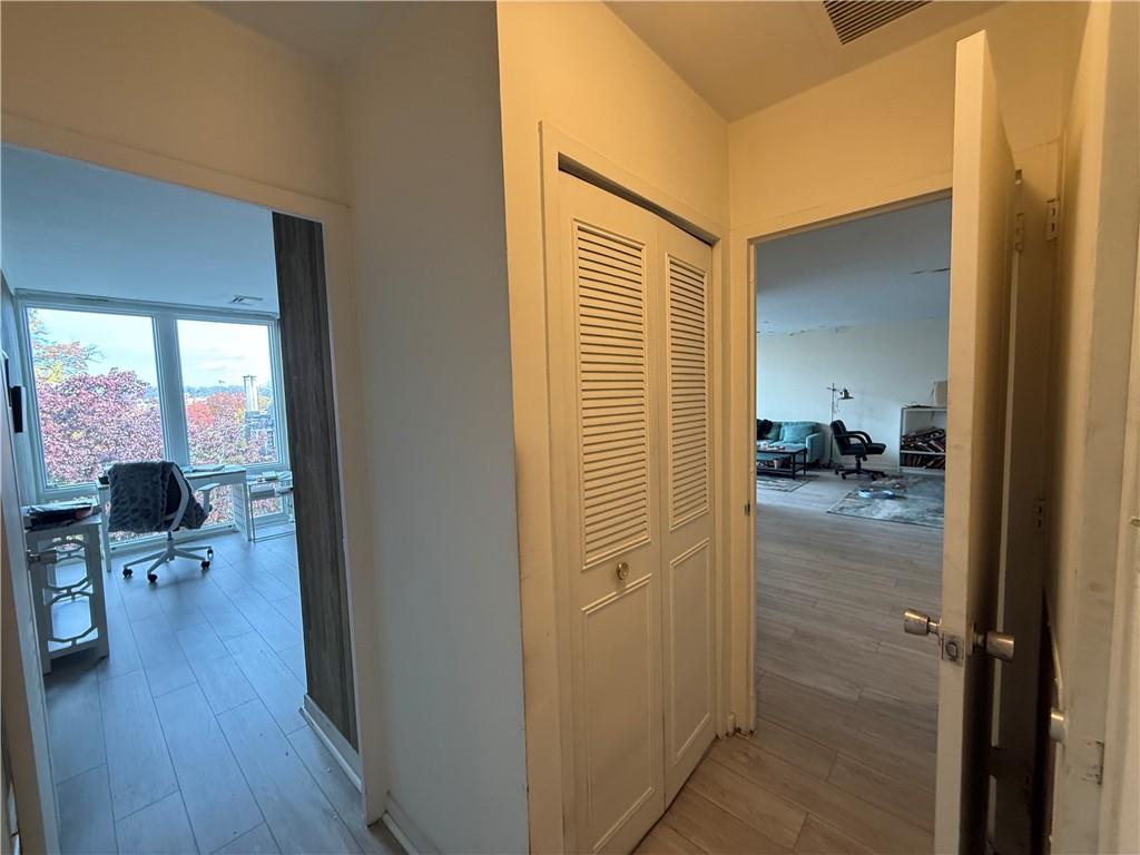 5100 Fifth Avenue, Unit 509 Pittsburgh, PA 15232 - Photo 14 of 26 a view of a hallway with wooden floor and furniture