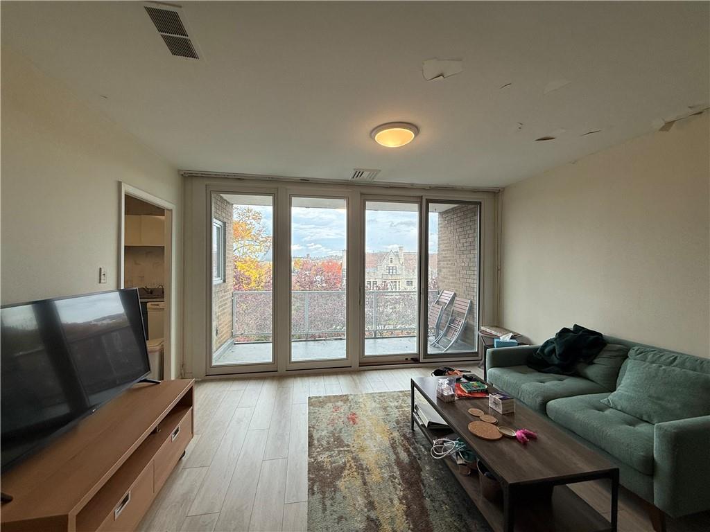 5100 Fifth Avenue, Unit 509 Pittsburgh, PA 15232 - Photo 5 of 26 a living room with furniture and a floor to ceiling window