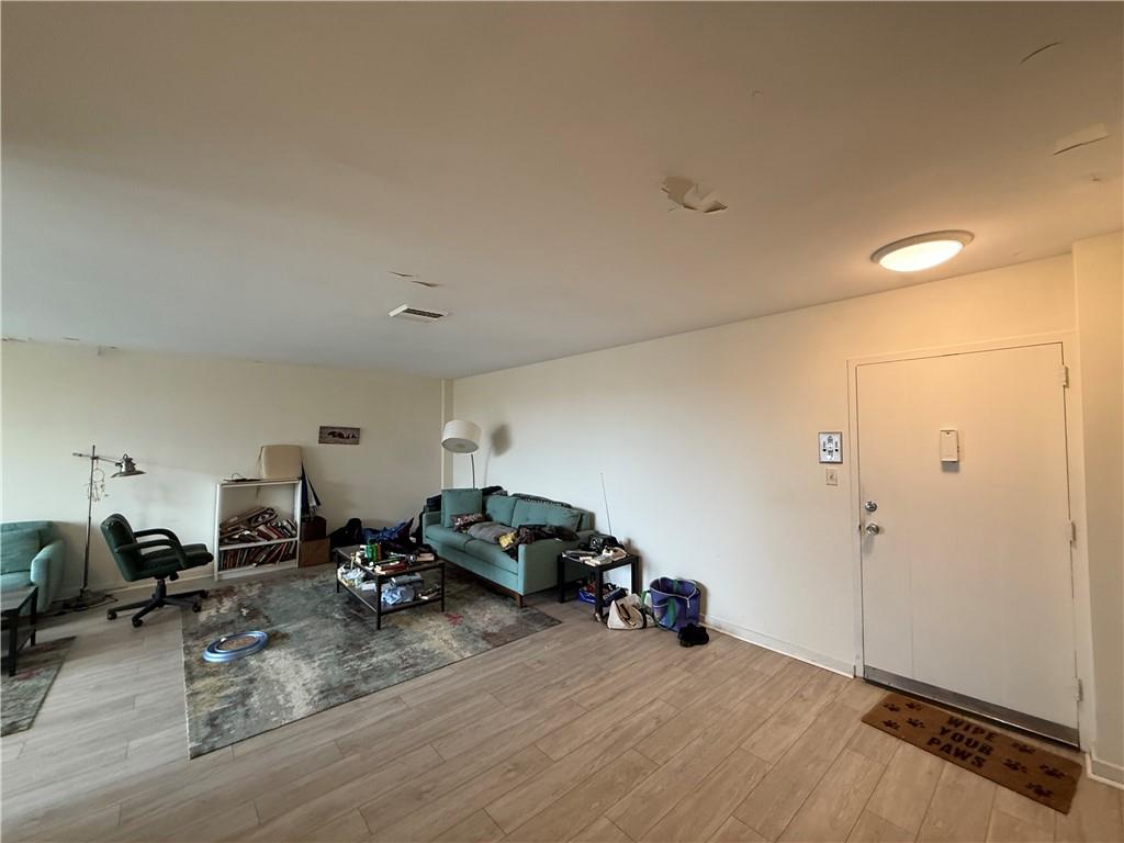 5100 Fifth Avenue, Unit 509 Pittsburgh, PA 15232 - Photo 7 of 26 a view of a livingroom with furniture and a flat screen tv