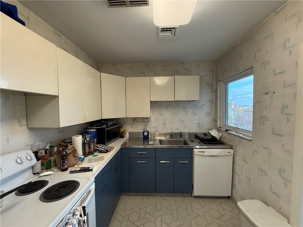 5100 Fifth Avenue, Unit 509 Pittsburgh, PA 15232 - Photo 10 of 26 a kitchen with a sink a stove and cabinets