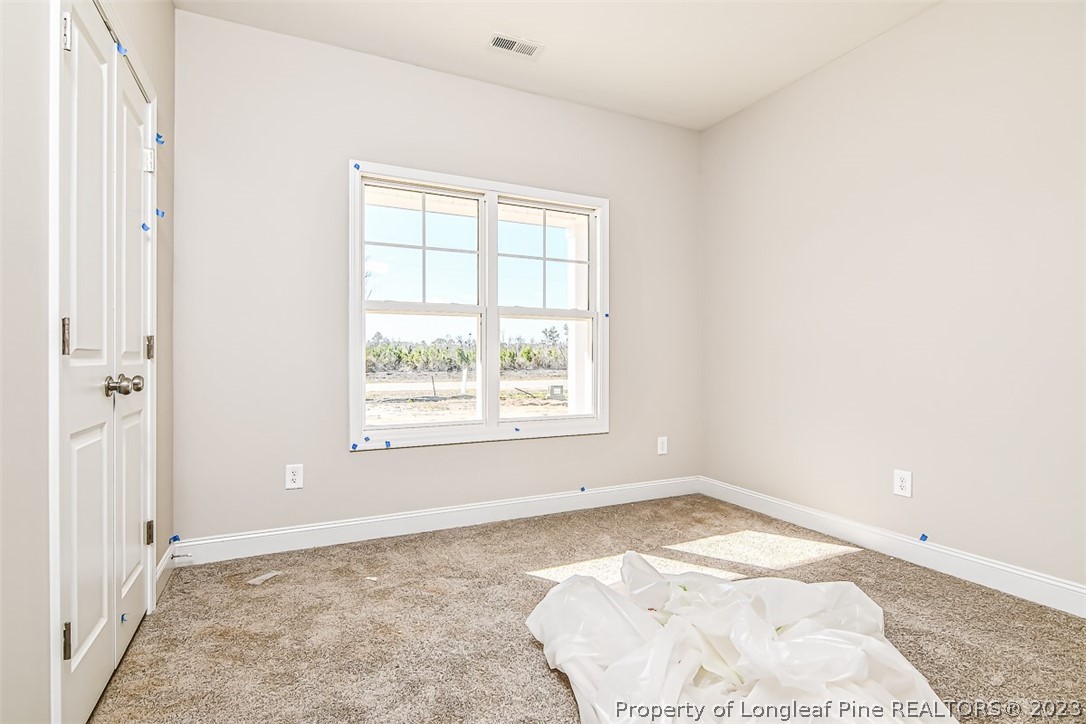 672 Barlow Road Parkton, NC 28371 - Photo 13 of 17 an empty room with a white walls and a window
