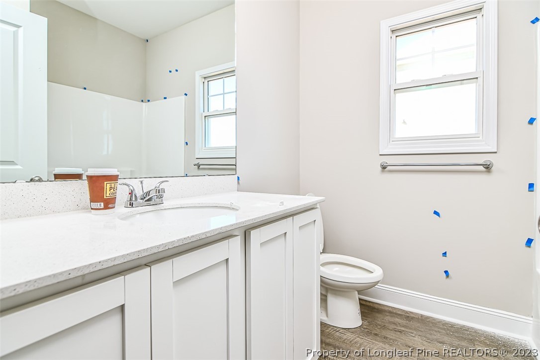 672 Barlow Road Parkton, NC 28371 - Photo 15 of 17 a bathroom with a sink a toilet and a window
