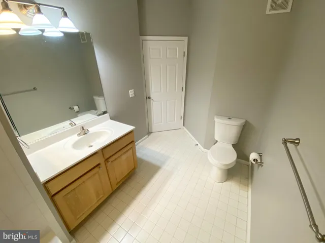 a bathroom with a sink mirror and toilet