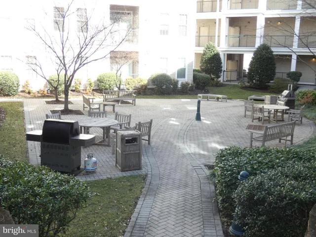 a view of a patio with table and chairs and potted plants