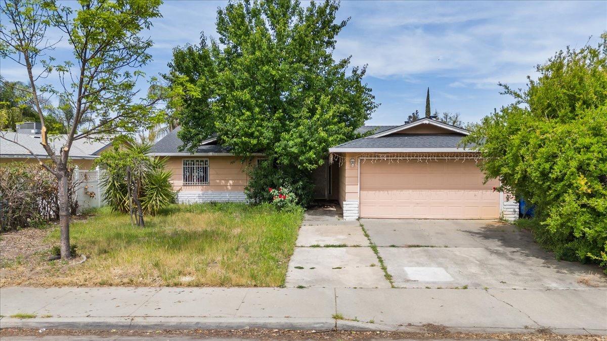 1813 Torrid Avenue Modesto, CA 95358 - Photo 1 of 1 a front view of a house with a yard and garage