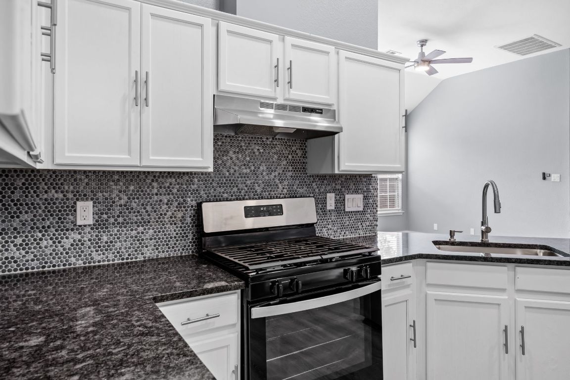 1214 Vargas Road, Unit B Austin, TX 78741 - Photo 11 of 25 a kitchen with stainless steel appliances granite countertop a stove and a granite counter tops