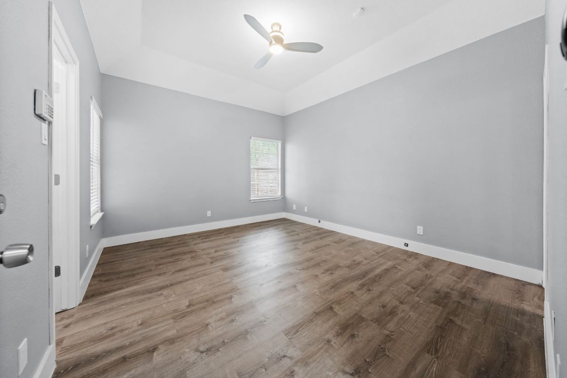 1214 Vargas Road, Unit B Austin, TX 78741 - Photo 12 of 25 wooden floor in an empty room with a window