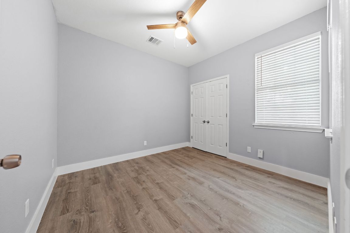 1214 Vargas Road, Unit B Austin, TX 78741 - Photo 17 of 25 wooden floor in an empty room with a window
