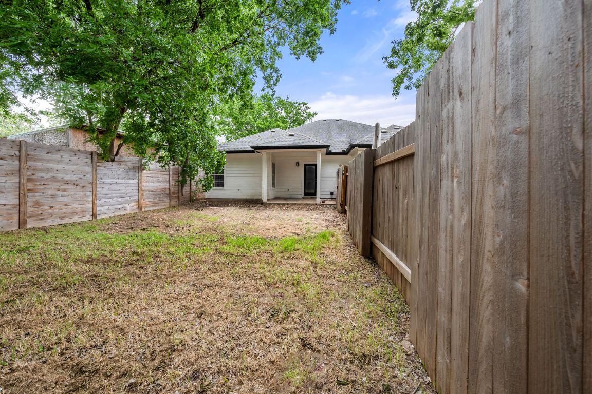 1214 Vargas Road, Unit B Austin, TX 78741 - Photo 22 of 25 a view of a house with a small yard and a large tree