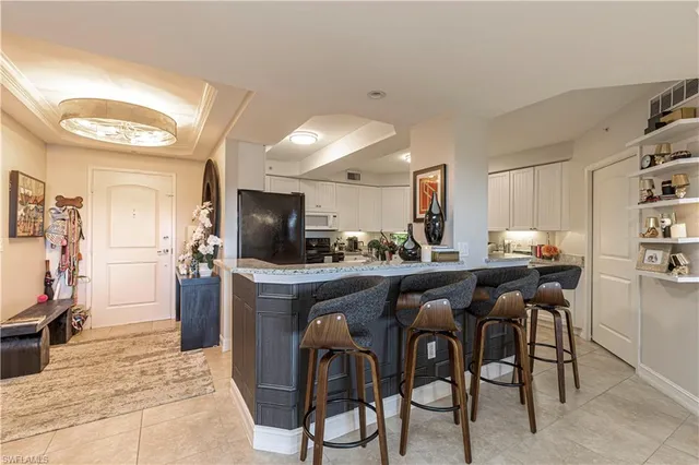 a kitchen with stainless steel appliances kitchen island granite countertop a table and chairs in it