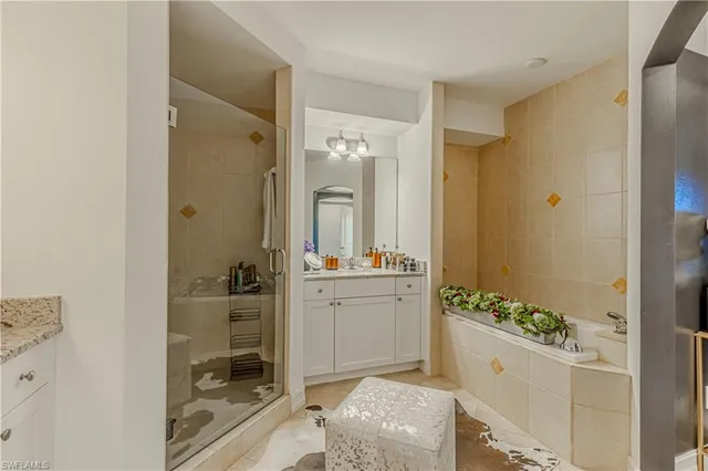 a bathroom with a granite countertop sink mirror and shower