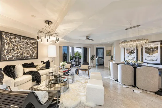a living room with furniture and a chandelier