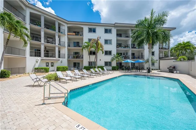 a view of a house with swimming pool and sitting area