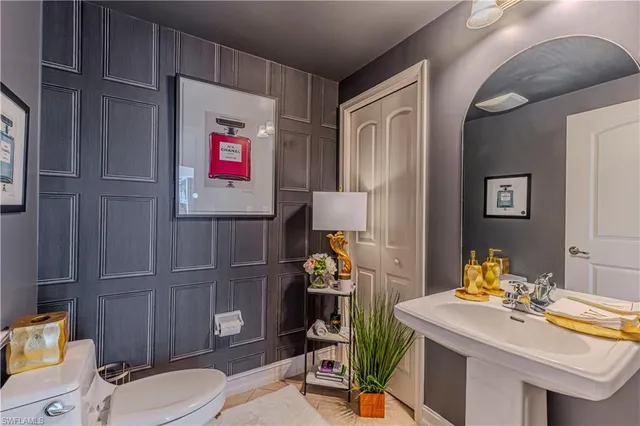 a bathroom with a sink mirror vanity and toilet