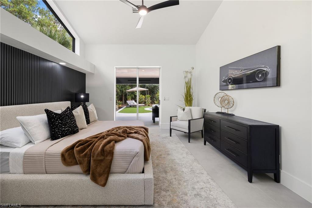 4521 3rd Avenue Northwest Naples, FL 34119 - Photo 15 of 46 a bedroom with furniture and a flat screen tv