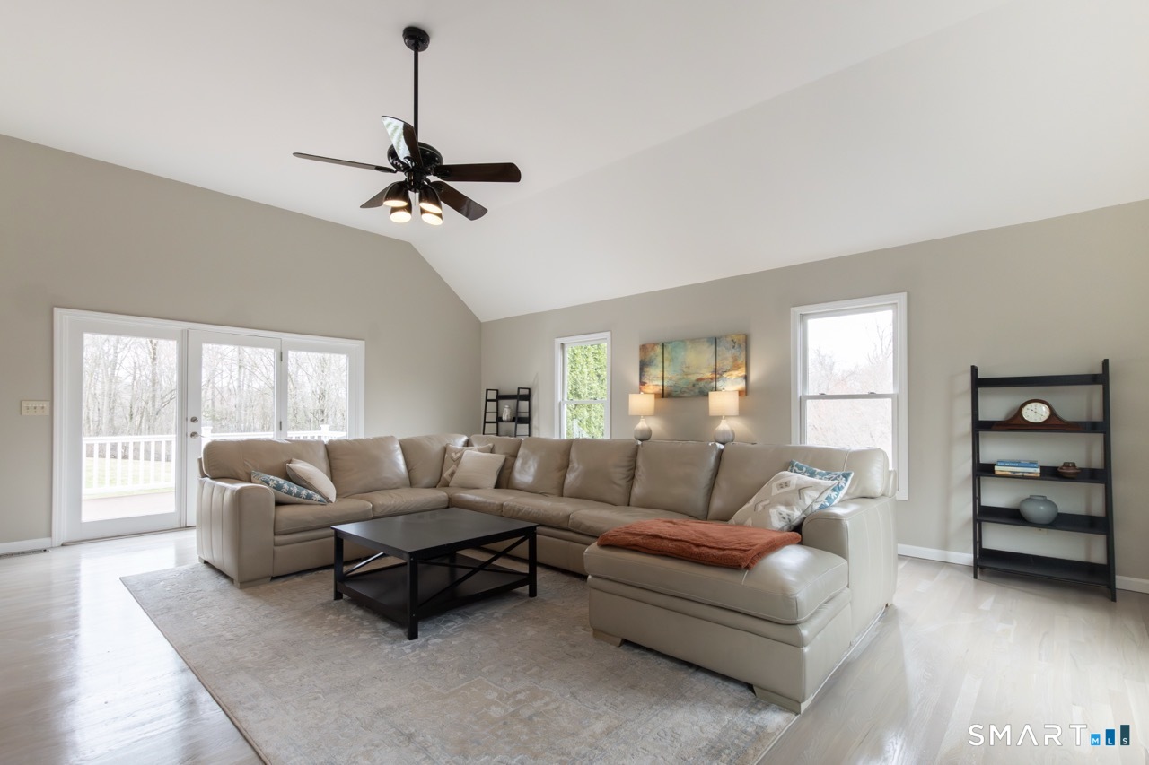 16 Shadowood Lane Trumbull, CT 06611 - Photo 11 of 39 a living room with furniture a ceiling fan and a window