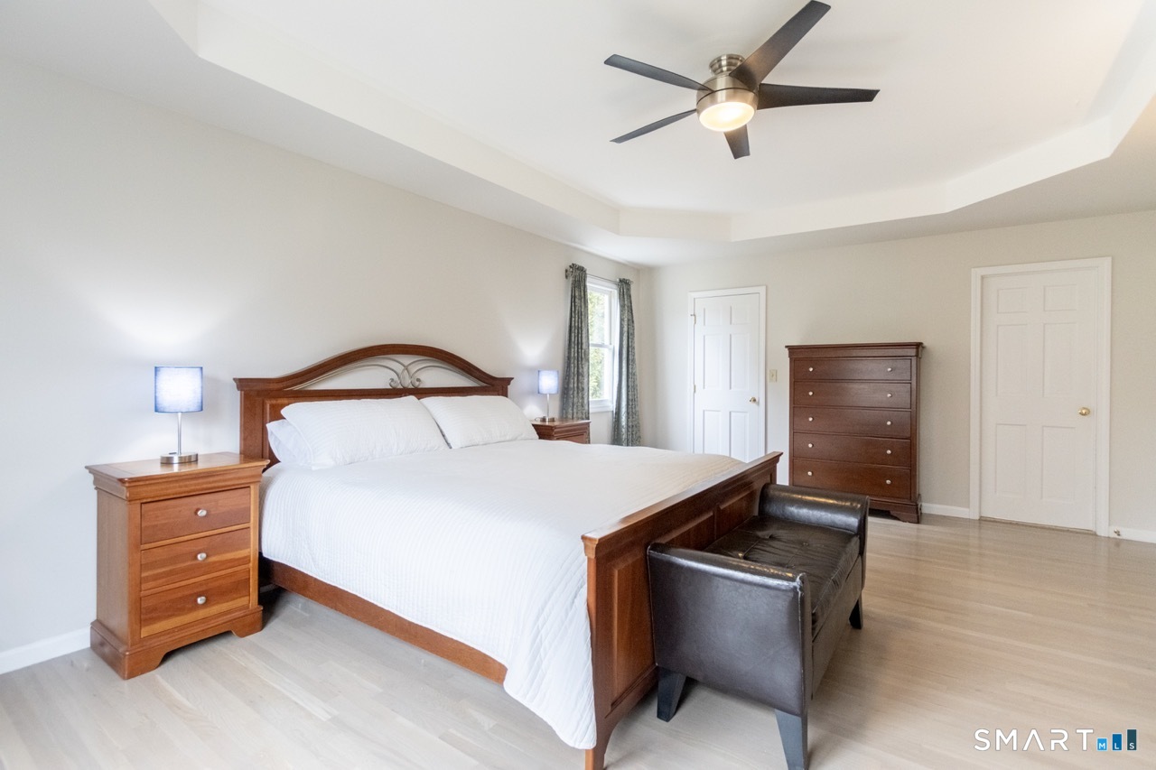 16 Shadowood Lane Trumbull, CT 06611 - Photo 18 of 39 a bedroom with a bed and a lamp