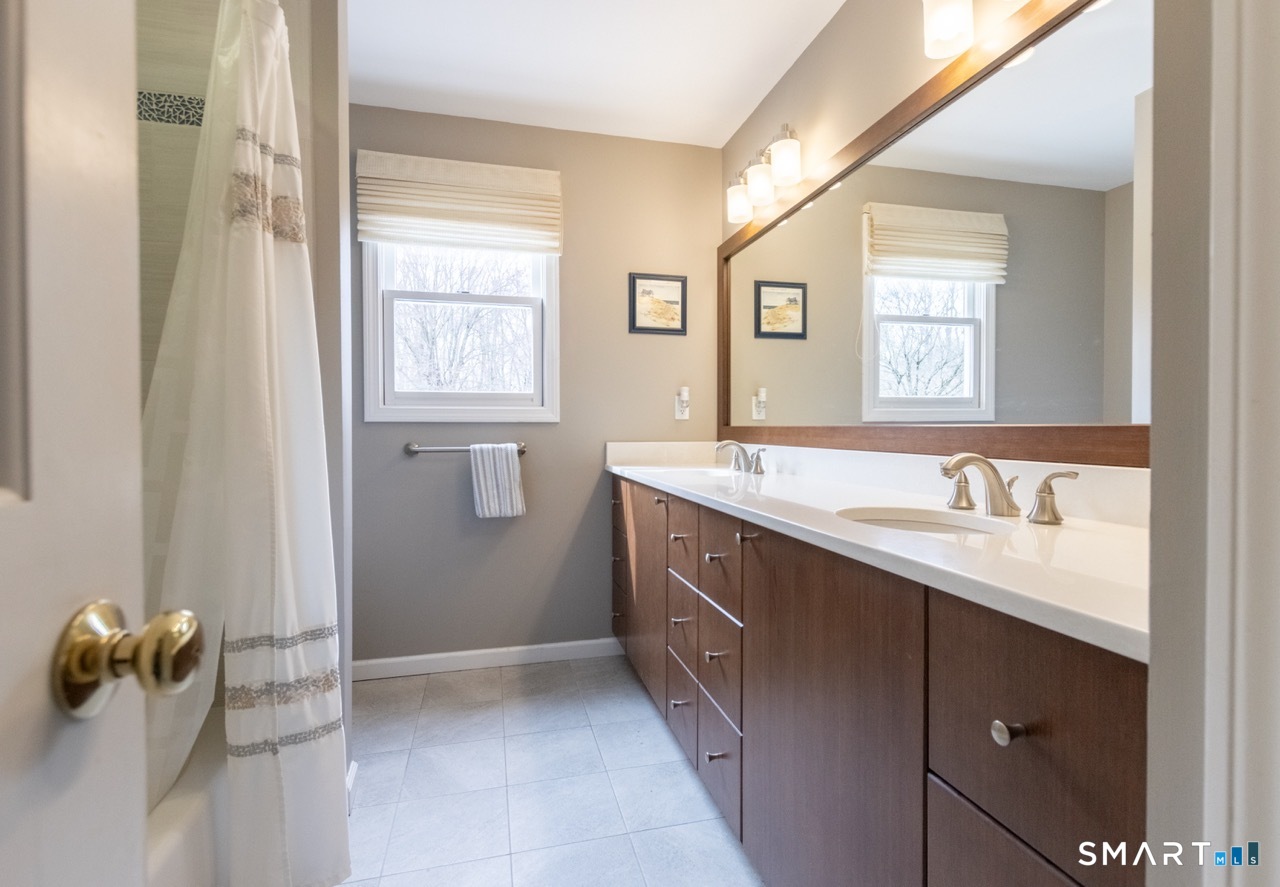 16 Shadowood Lane Trumbull, CT 06611 - Photo 24 of 39 a bathroom with a sink a mirror and shower