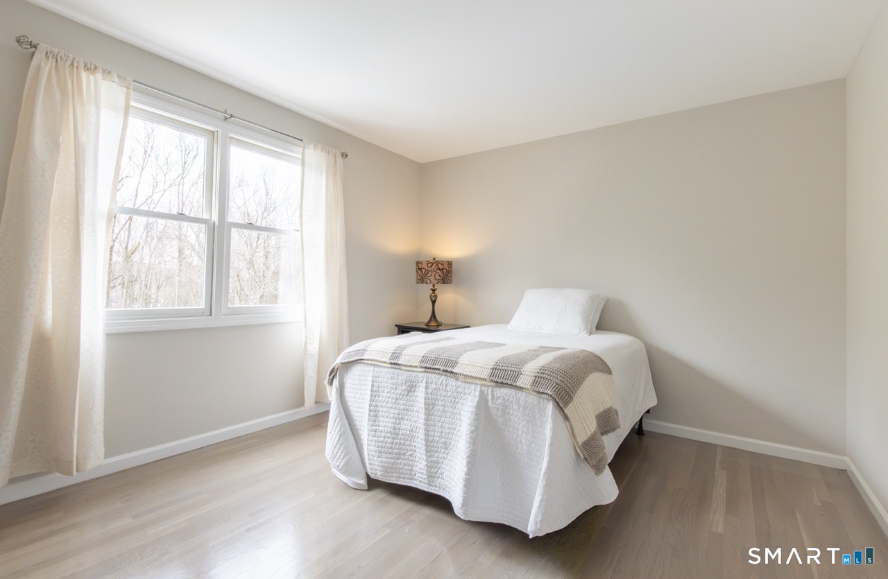 16 Shadowood Lane Trumbull, CT 06611 - Photo 25 of 39 a bed sitting in a bedroom next to a window