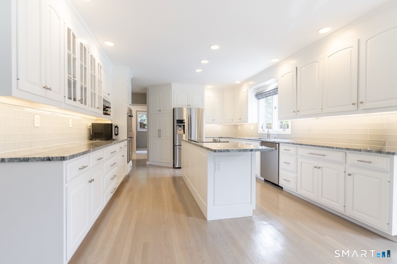 16 Shadowood Lane Trumbull, CT 06611 - Photo 4 of 39 a kitchen with white cabinets and white appliances