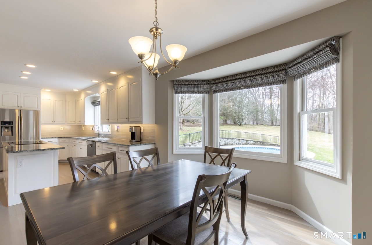 16 Shadowood Lane Trumbull, CT 06611 - Photo 5 of 39 a view of a dining room with furniture wooden floor and chandelier