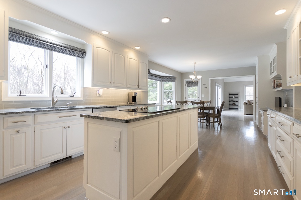 16 Shadowood Lane Trumbull, CT 06611 - Photo 6 of 39 a kitchen with granite countertop a sink and white cabinets