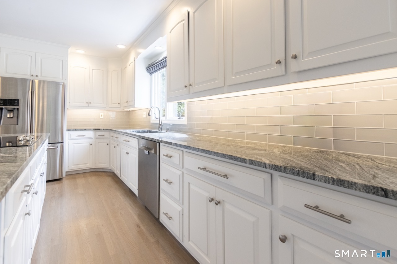 16 Shadowood Lane Trumbull, CT 06611 - Photo 8 of 39 a kitchen with stainless steel appliances granite countertop a sink a stove and cabinets