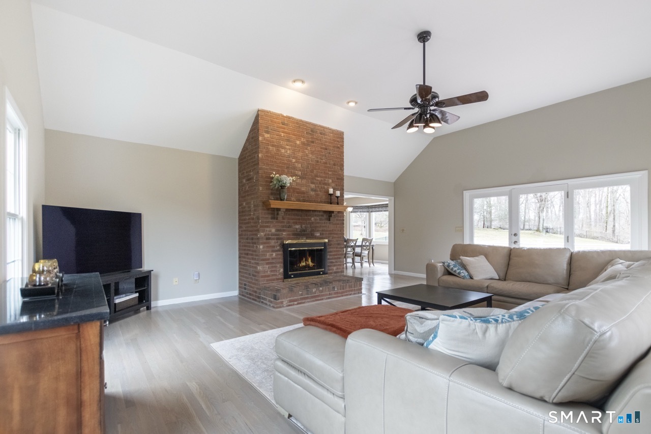 16 Shadowood Lane Trumbull, CT 06611 - Photo 9 of 39 a living room with furniture fireplace and a flat screen tv
