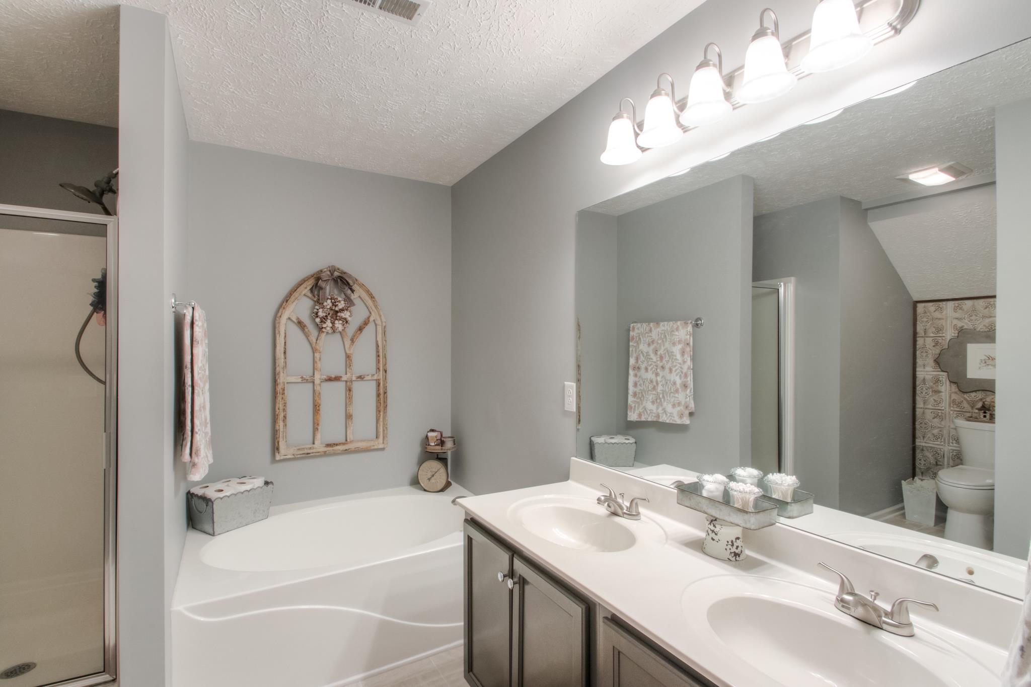 693 Crescent Road Murfreesboro, TN 37128 - Photo 12 of 23 a bathroom with a tub sink and mirror
