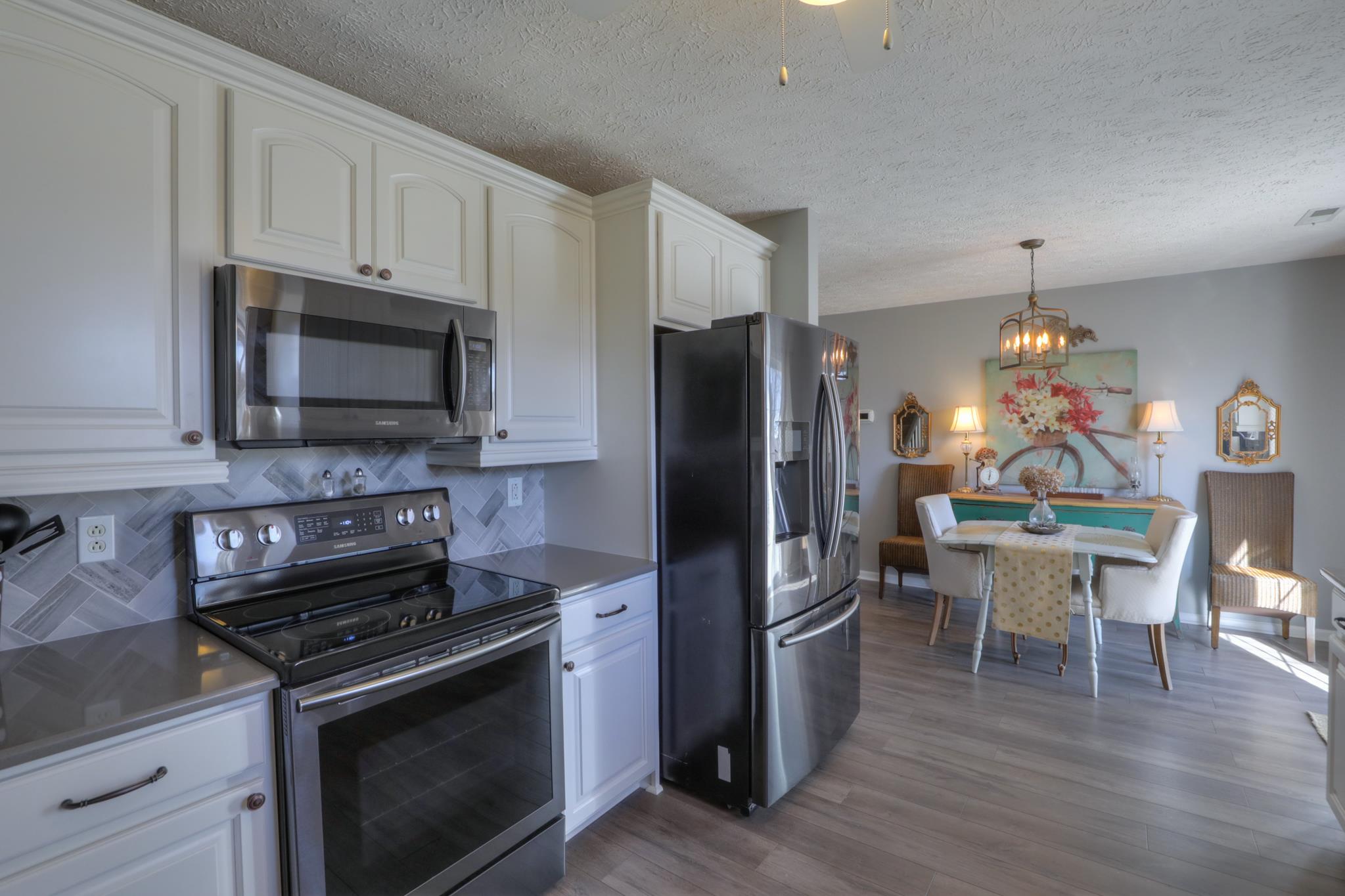 693 Crescent Road Murfreesboro, TN 37128 - Photo 5 of 23 a kitchen with a stove a microwave and refrigerator