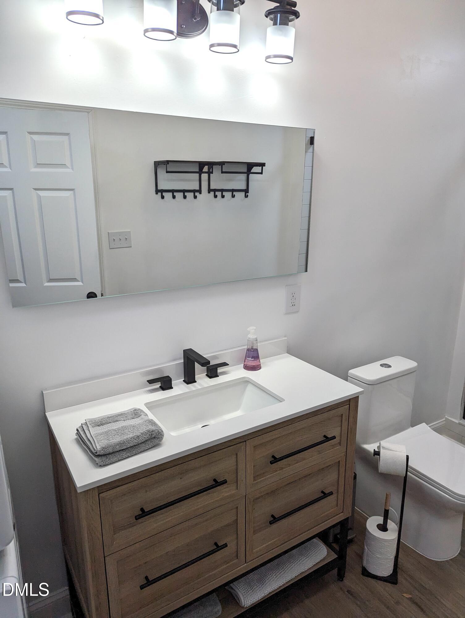 4816 Whitehall Avenue Raleigh, NC 27604 - Photo 15 of 23 a bathroom with a sink and a toilet