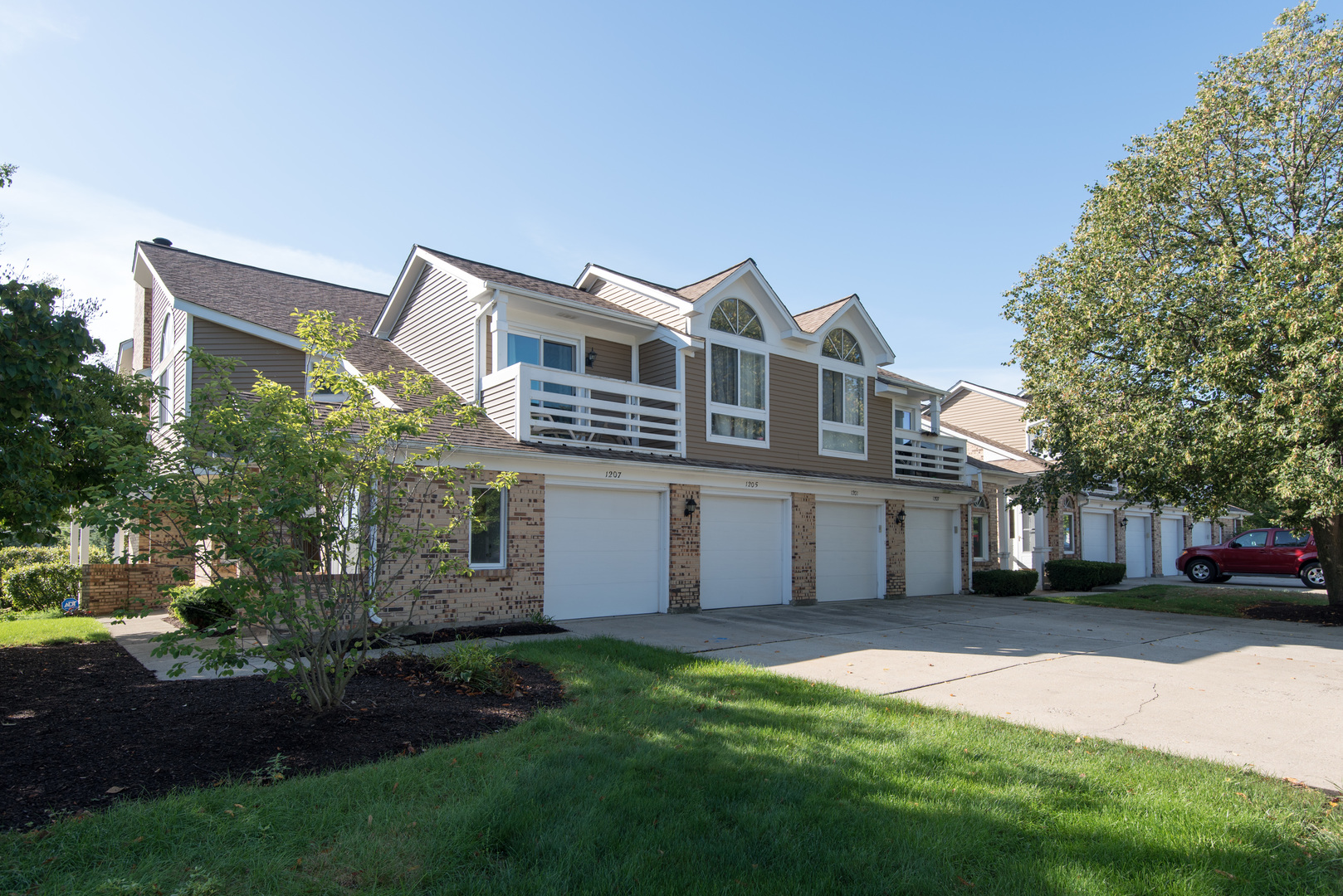 1201 Ranchview Court Buffalo Grove, IL 60089 - Photo 1 of 25 a front view of a house with a garden and yard
