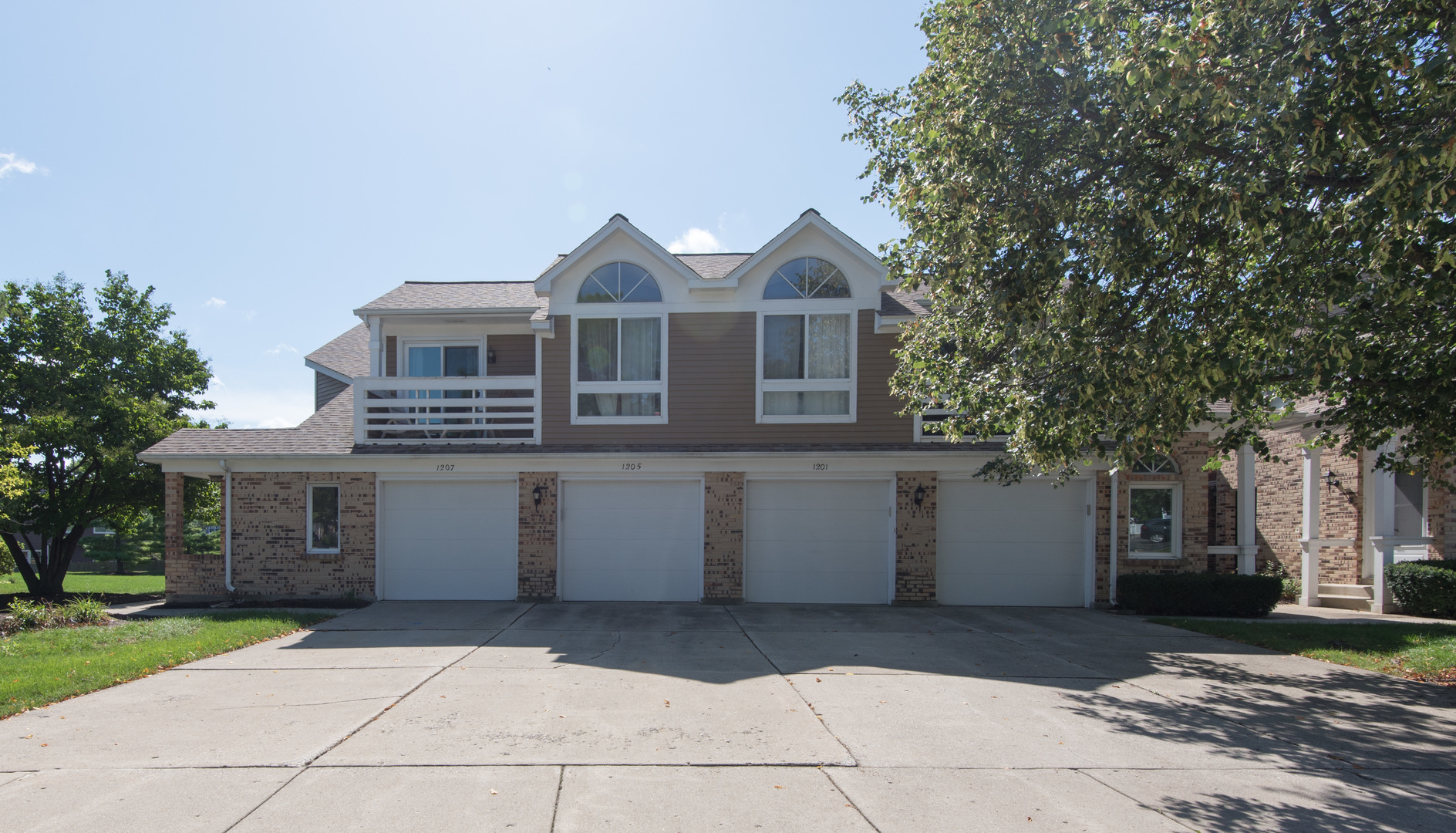 1201 Ranchview Court Buffalo Grove, IL 60089 - Photo 2 of 25 a front view of a house with a yard and garage