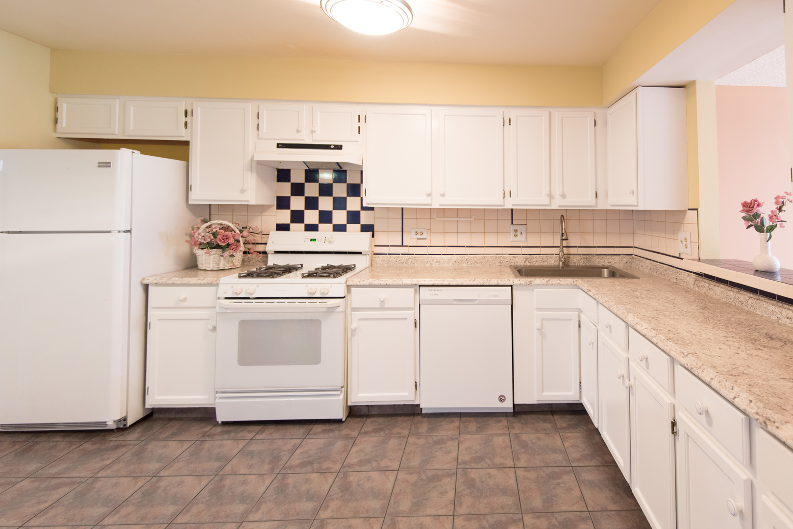 1201 Ranchview Court Buffalo Grove, IL 60089 - Photo 4 of 25 a kitchen with white cabinets sink and white appliances