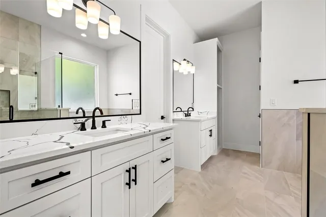 a spacious bathroom with double sink and a mirror