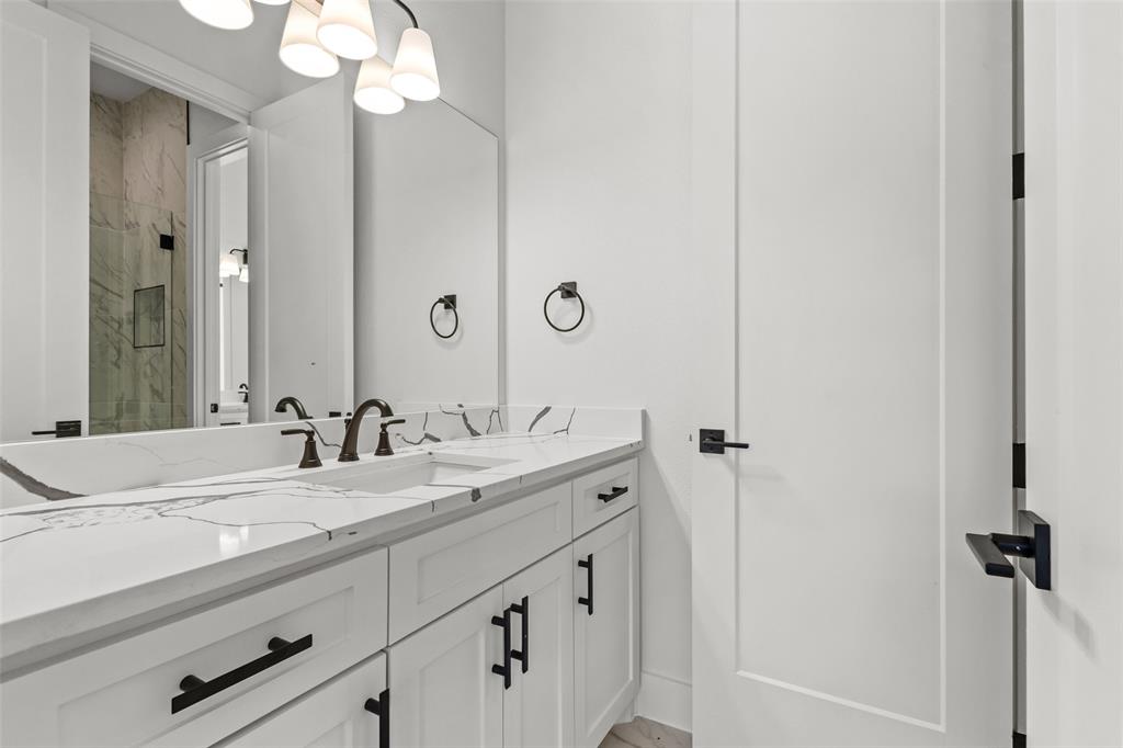 1418 Oak Hill Road Van Alstyne, TX 75495 - Photo 26 of 39 a bathroom with a sink and a mirror