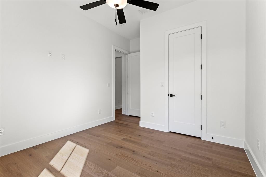 1418 Oak Hill Road Van Alstyne, TX 75495 - Photo 28 of 39 an empty room with wooden floor cabinet and a ceiling fan
