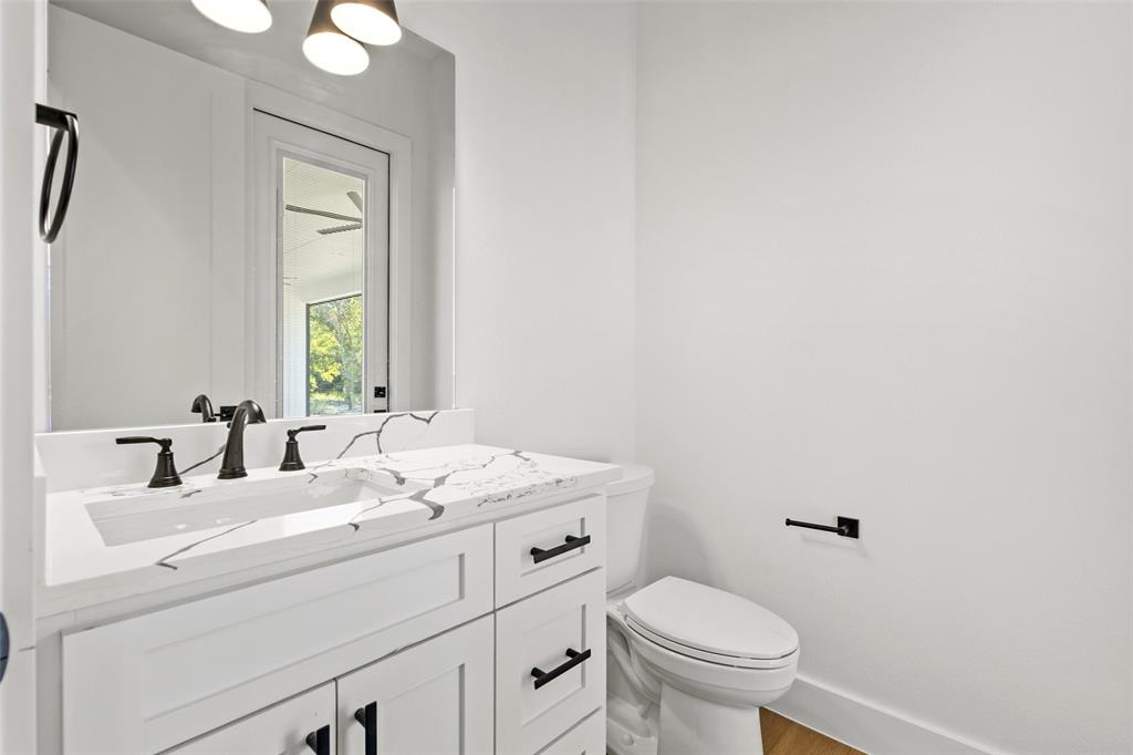 1418 Oak Hill Road Van Alstyne, TX 75495 - Photo 30 of 39 a bathroom with a toilet sink and mirror