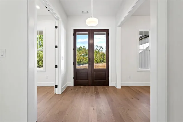 a view of a room with wooden floor and windows