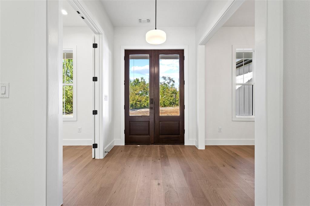 1418 Oak Hill Road Van Alstyne, TX 75495 - Photo 3 of 39 a view of a room with wooden floor and windows