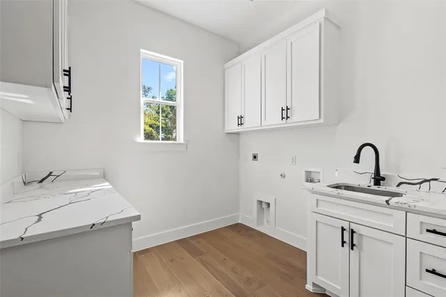 a view of a kitchen with sink and cabinets