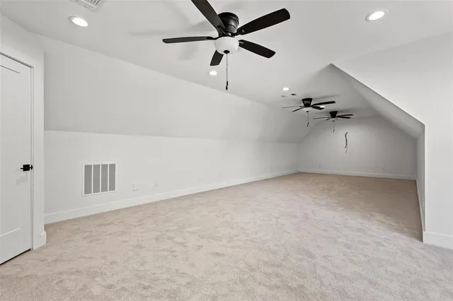 an empty room with ceiling fan and window