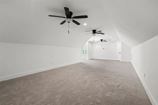 a view of a big room with a ceiling fan